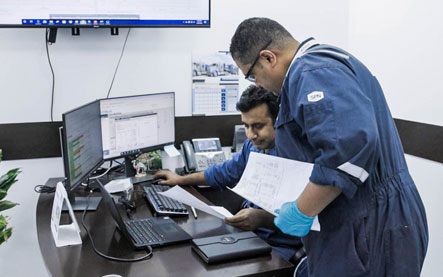 Two Superior Cementing technicians reviewing chemical formulas at a desk.